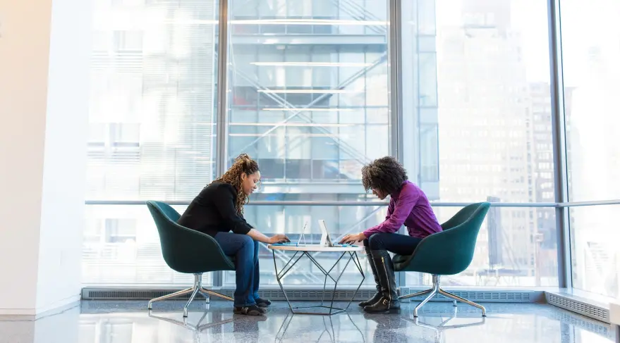 two girls sitting at a table